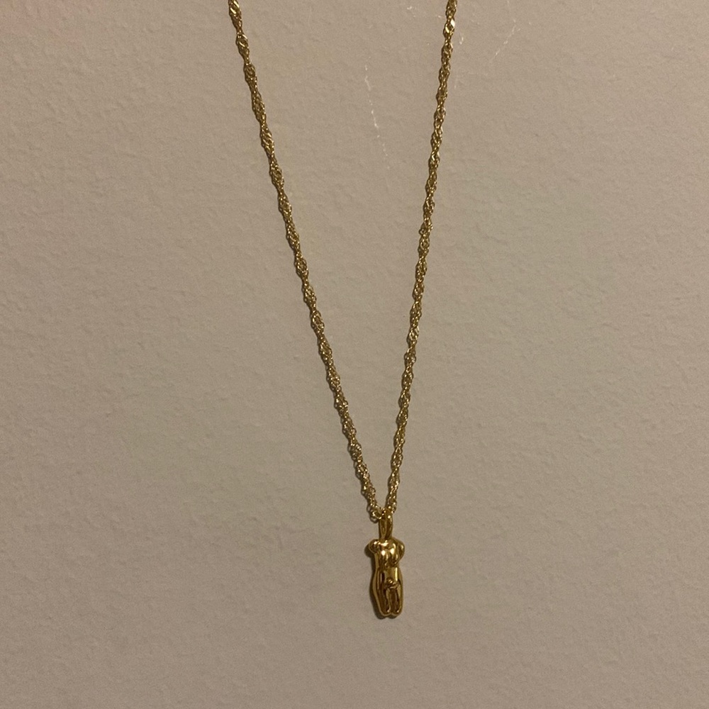 Gold female figure necklace